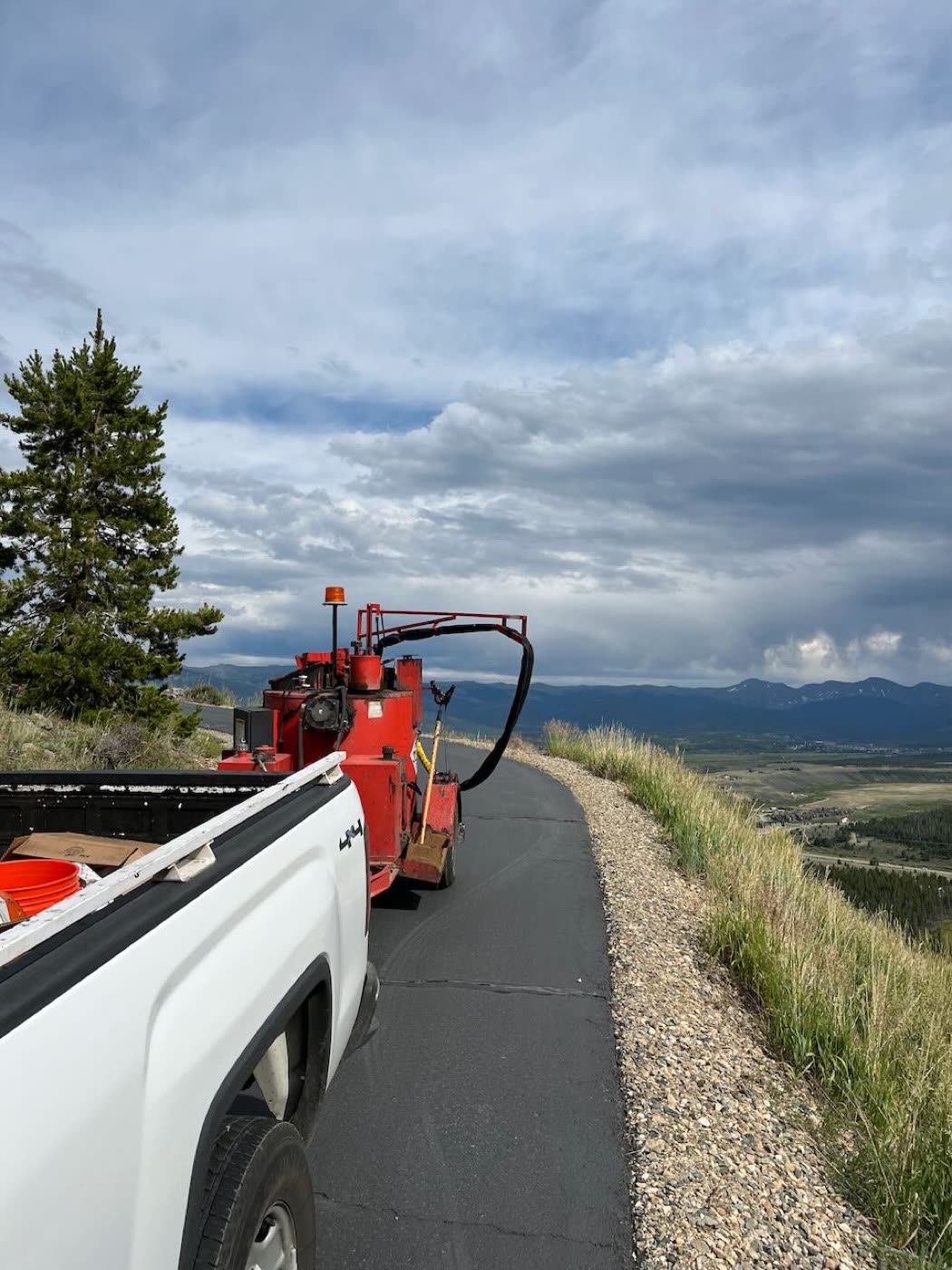Asphalt driveway before and after seal coating — Grand County