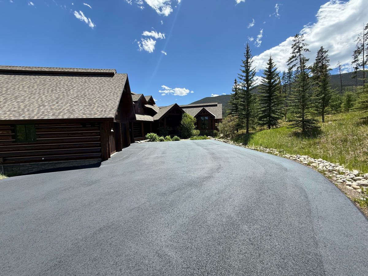 Close-up of finished driveway seal coat at a log cabin home — Grand County, CO