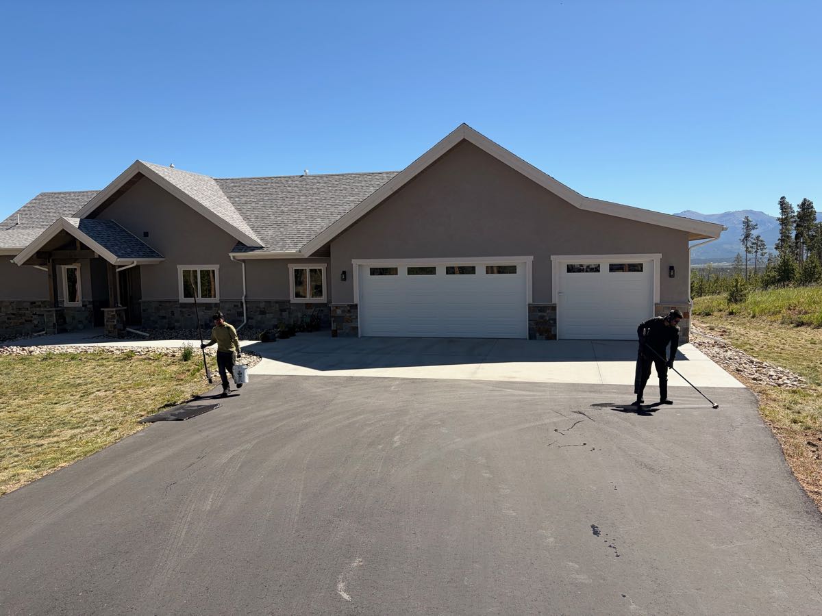 GC Asphalt Care crew applying seal coat to a residential driveway